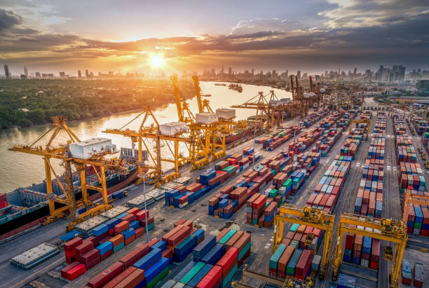 istock Logistics and transportation of Container Cargo ship and Cargo plane with working crane bridge in shipyard at sunrise, logistic import export and transport industry background 1151090846