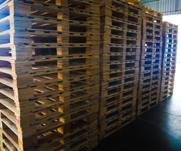 istock Forklift operator handling wooden pallets in warehouse cargo for transportation to customer factory 1151094936