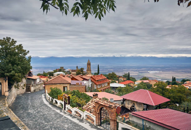 Signagi town in Georgia Church and houses at the street of Signagi town with Alazani valley and mountains at background in Georgia kakheti georgia stock pictures, royalty-free photos & images