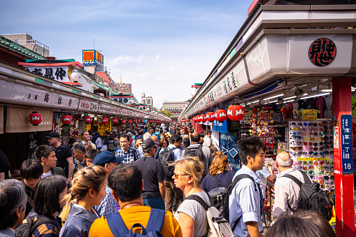 Nakamise, a shopping street that has been providing temple visitors with a variety of traditional, local snacks and tourist souvenirs for centuries. The bustling shopping street leads visitors towards the Sensoji Temple.