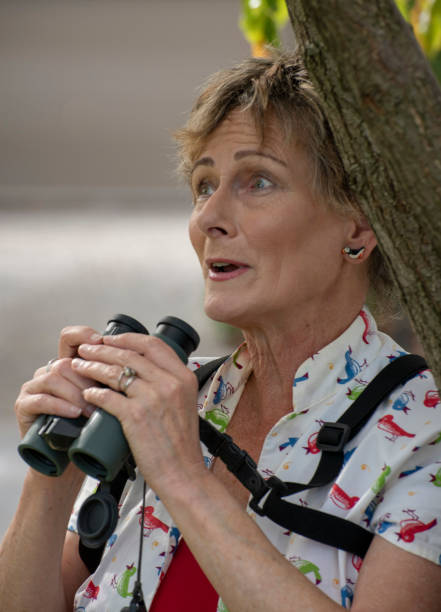 istock Mature woman bird watching with binoculars. 1151099208
