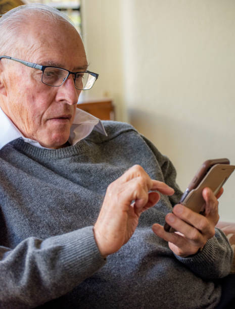 istock Senior male uses his mobile phone. 1151099968