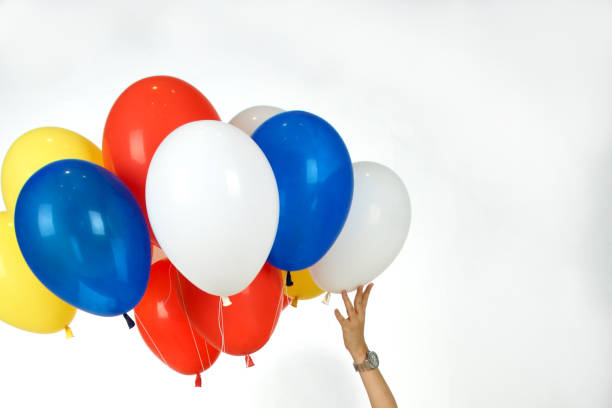 istock Group colorful balloons and hand on isolated white background. 1151099997