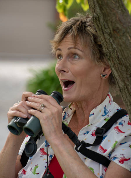 istock Mature woman bird watching with binoculars. 1151100789