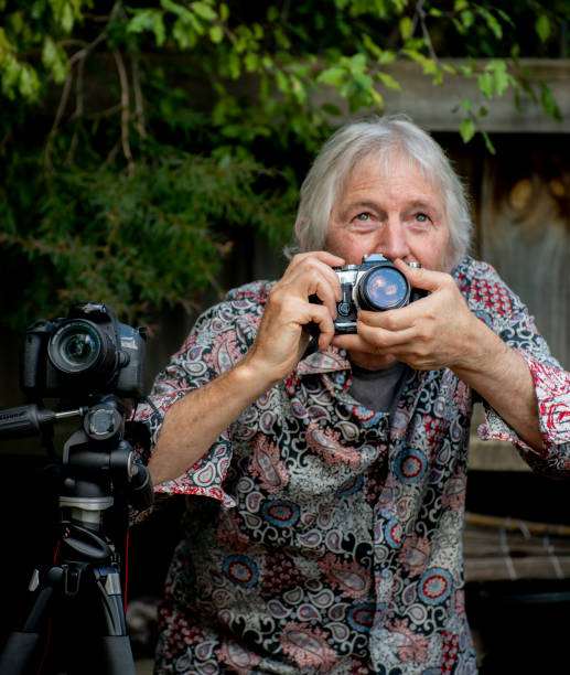 istock Older man with a passion for photography searches for his next subject. 1151100907