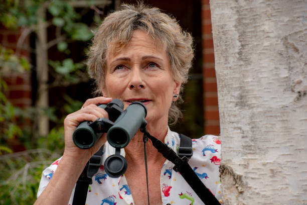 istock Mature woman bird watching with binoculars. 1151101050