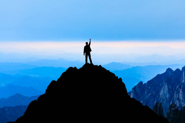 Happy man gesture of triumph with hands in the air,conceptual scene Happy man gesture of triumph with hands in the air,travel concept scene huangshan mountains stock pictures, royalty-free photos & images