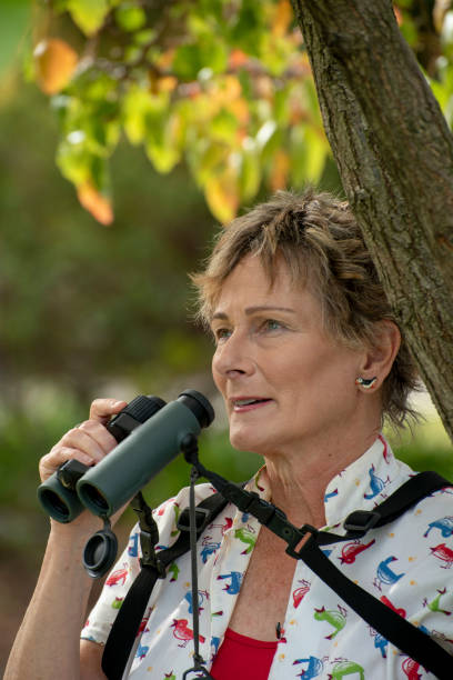 istock Mature woman bird watching with binoculars. 1151101998