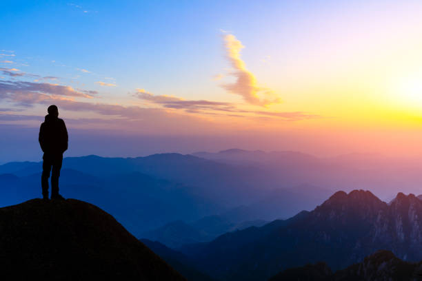 istock Man on top of mountain,conceptual scene 1151102014