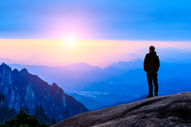 istock Man on top of mountain,conceptual scene 1151102195