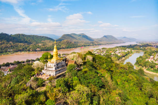 The golden pagoda of Wat Chom Si on the top of Mount Phou Si, Luang Prabang, Lao Luang Prang Laos View. Mount Phousi. South East Asia, View of town and surrounding countryside. golden pagoda of Wat Chom Si on the top of Mount Phou Si laos photos stock pictures, royalty-free photos & images
