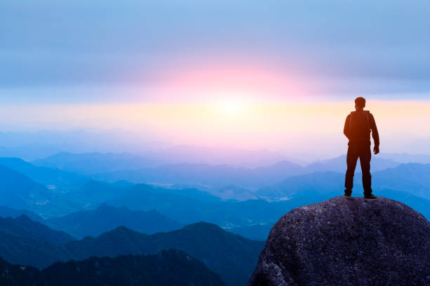 istock Young happy backpacker on top of a mountain enjoying valley view 1151103471