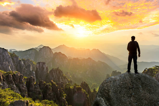young happy backpacker on top of a mountain enjoying valley view - sunrise asia china climbing imagens e fotografias de stock