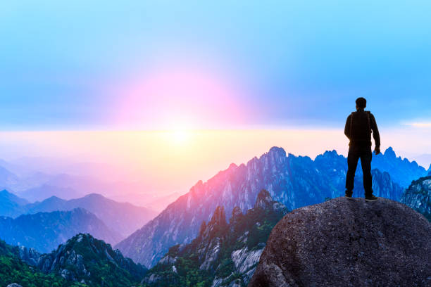 istock Young happy backpacker on top of a mountain enjoying valley view 1151103581