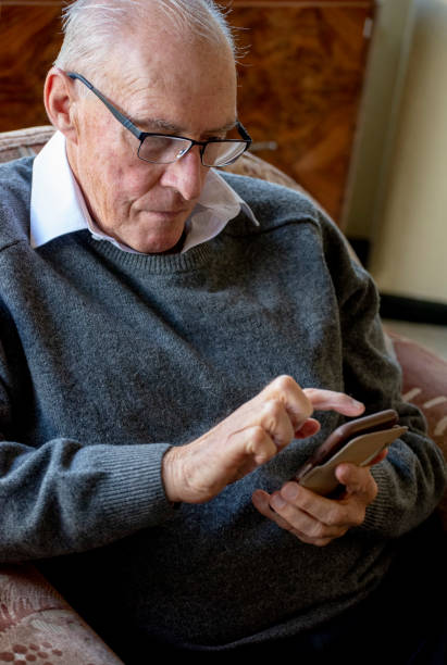 istock Senior male uses his mobile phone. 1151104467