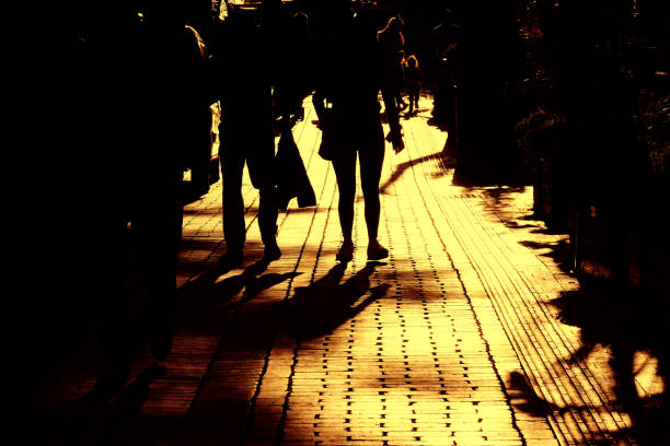 Close up image of silhouetted people walking on city street in Antalya, Turkey