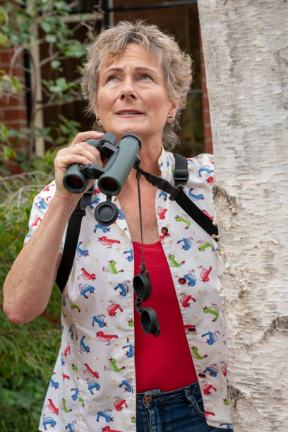 istock Mature woman bird watching with binoculars. 1151104807