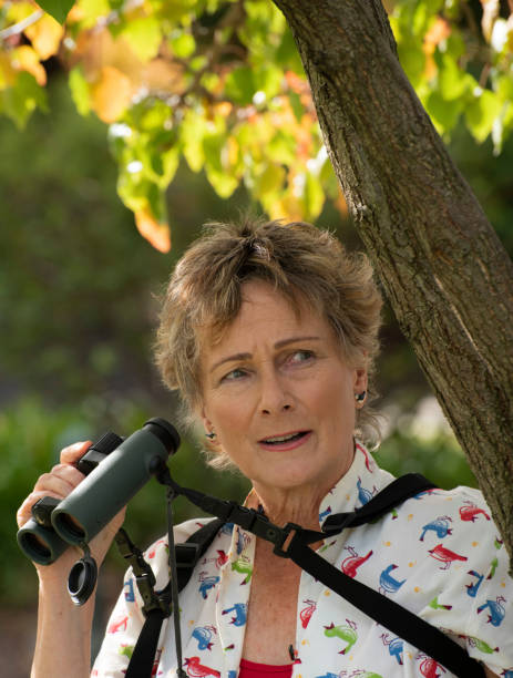 istock Mature woman bird watching with binoculars. 1151104872