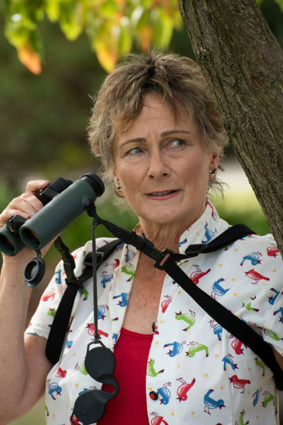 istock Mature woman bird watching with binoculars. 1151105190