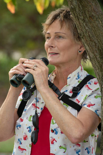 istock Mature woman bird watching with binoculars. 1151105861