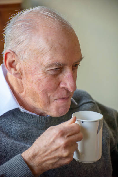 istock older man enjoys a mug of tea on a winters afternoon. 1151105946