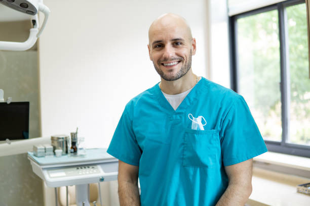 istock Young smiling dentist in his dental clinic 1151106472