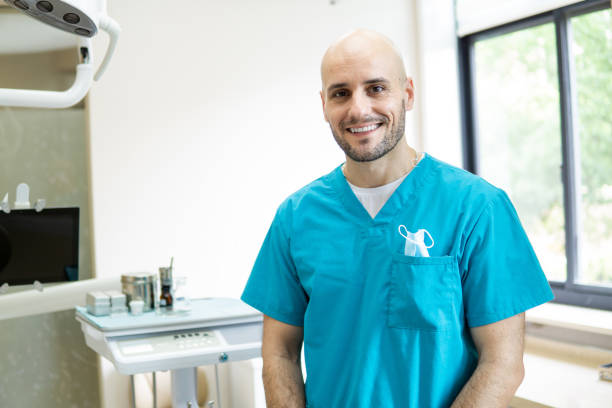 istock Young smiling dentist in his dental clinic 1151106511