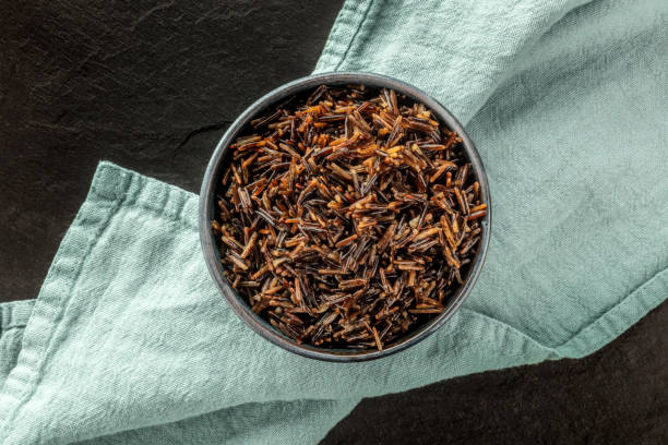 istock Wild black rice, shot from the top on a dark background with a place for text 1151109080