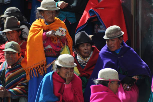 Alausi, Ecuador - August, 19, 2007: portrait of ecuadorian women walking in the colorful street of Alausi, Ecuador