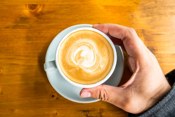 istock A cup of coffee in a cafe and a man's hands 1151110669