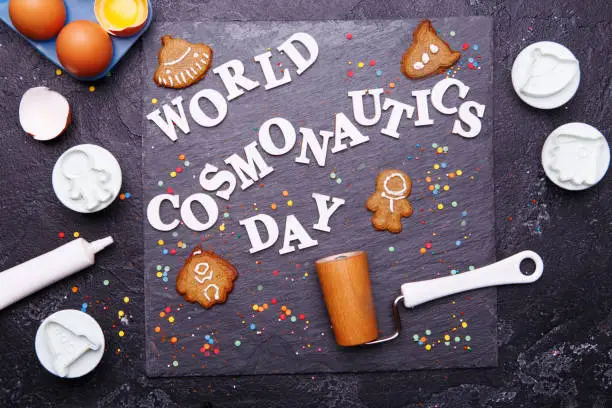 Text is World Cosmonautics day and cookies in form of astronaut, rocket, flying saucer and alien. Concept for Day of Cosmonautics, April 12.