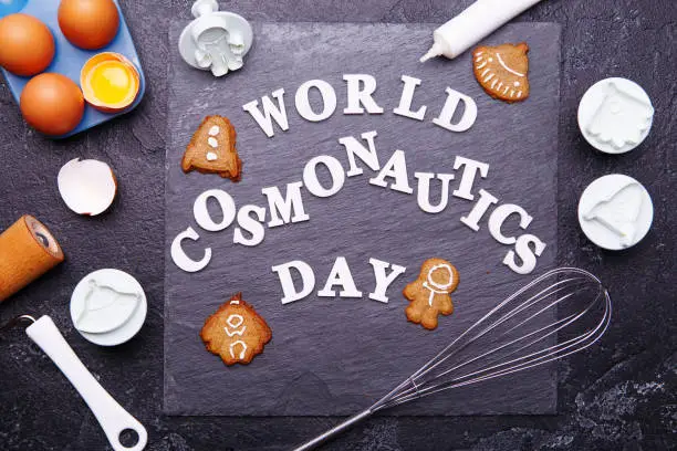 Text is World Cosmonautics day and cookies in form of astronaut, rocket, flying saucer and alien. Concept for Day of Cosmonautics, April 12.