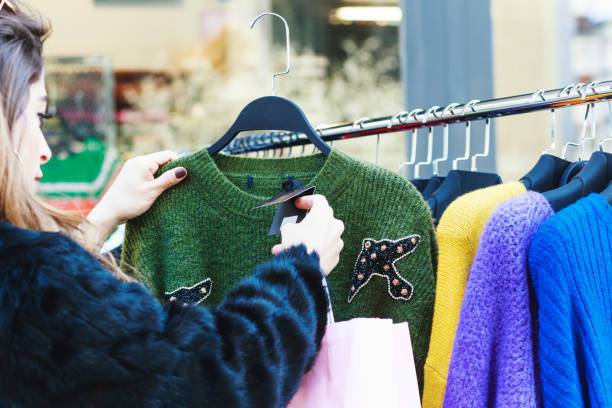 istock Young woman choosing clothes in the store 1151114184