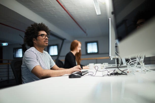 istock One business person working on computer, he is concentrated and focused on his task. 1151114450