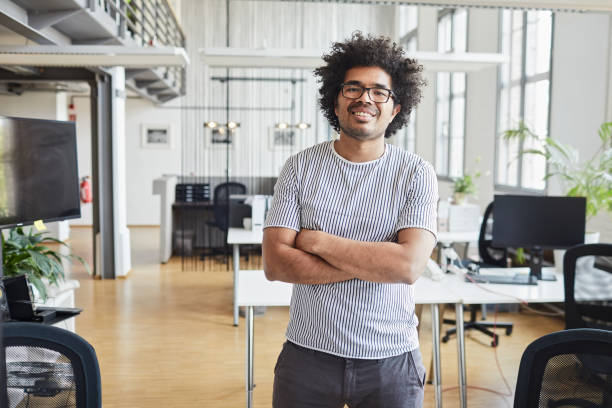 istock Business person portrait looking at camera. Standing in empty office with copy space. 1151114491