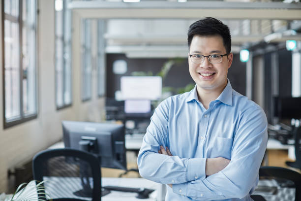 istock Business person portrait looking at camera. Standing in empty office with copy space. 1151114527