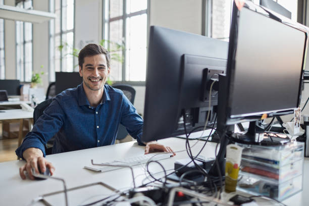istock Sitting at his desk and smiling at camera. 1151114528