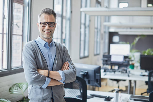 istock Business person portrait looking at camera. Standing in empty office with copy space. 1151114534