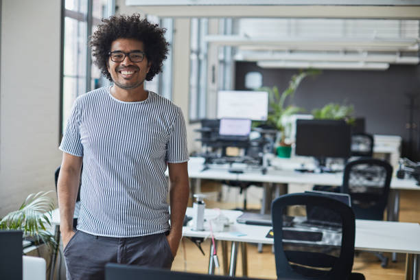 istock Business person portrait looking at camera. Standing in empty office with copy space. 1151114535