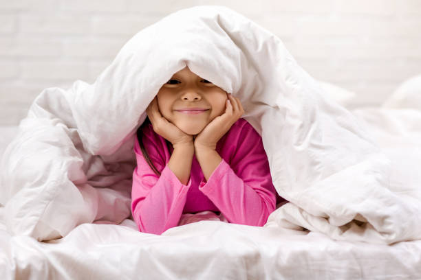 istock happy morning baby in bed. 1151115408