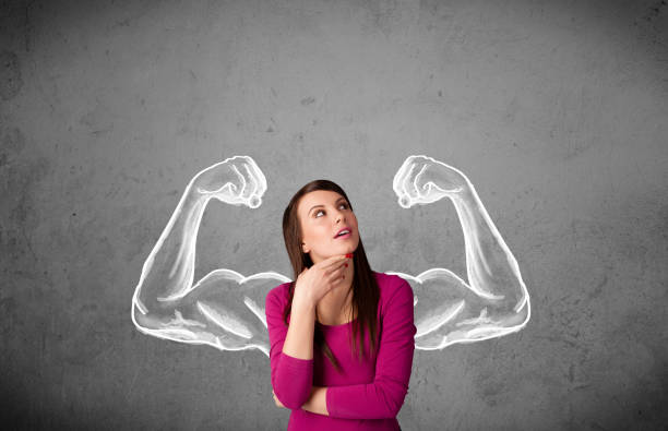 istock Young woman with strong muscled arms 1151115436