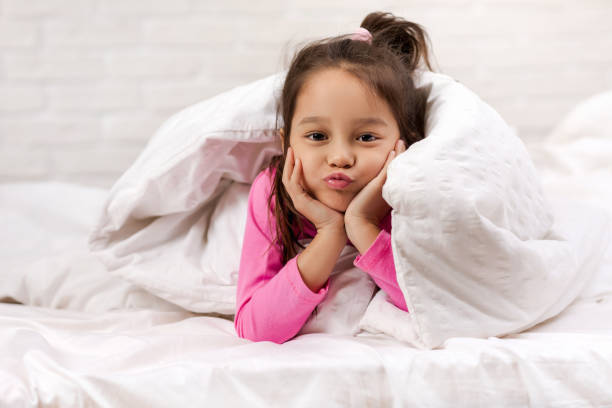 istock happy morning baby in bed. 1151115455