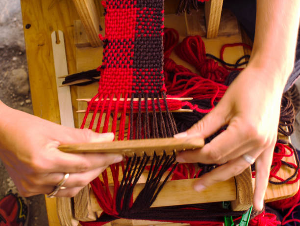 istock Weaving loom with knitted throw (muffler) red and brown in process 1151115498
