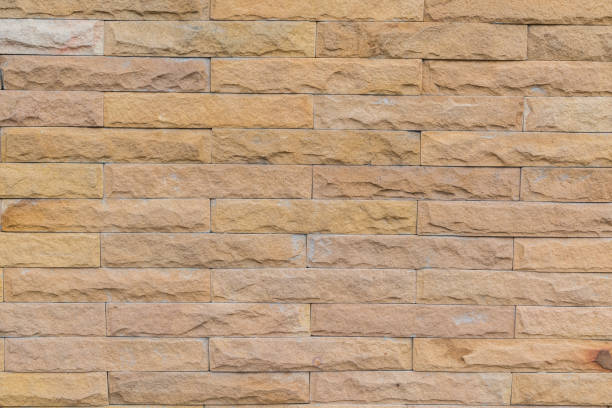 istock yellow stone wall  made with stone blocks 1151116725