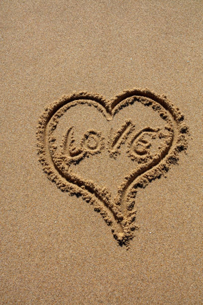 istock hashtag written by hand in the sand 1151117005