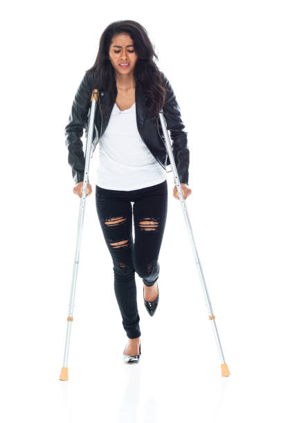 istock Bautiful woman wearing a leather jacket and using crutches 1151117032