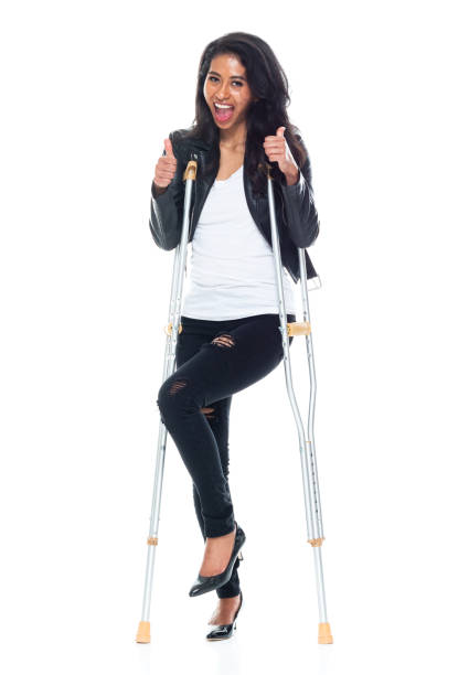 istock Bautiful woman wearing a leather jacket and using crutches 1151117048