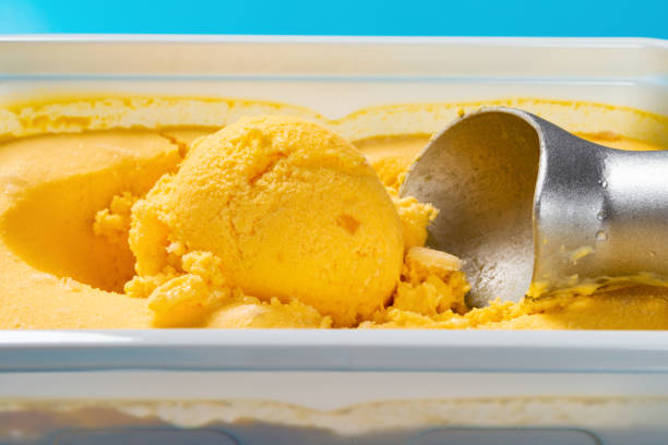 istock mango flavor ice cream ball and spoon close up 1151120258