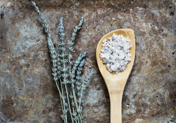 Dried lavender flatlay on rustic background with bathsalt in a spoon straight position