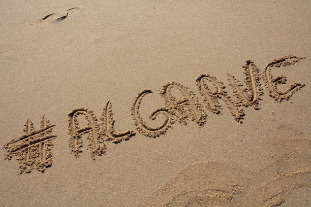 istock hashtag written by hand in the sand 1151124464